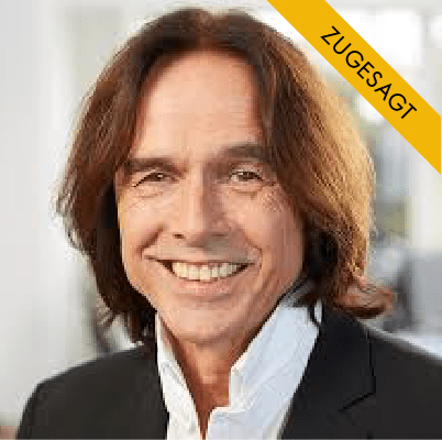 Klaus Rempe, Mann mit schulterlangem braunem Haar, dunklem Anzug und hellblauem Hemd, vor grauem Hintergrund