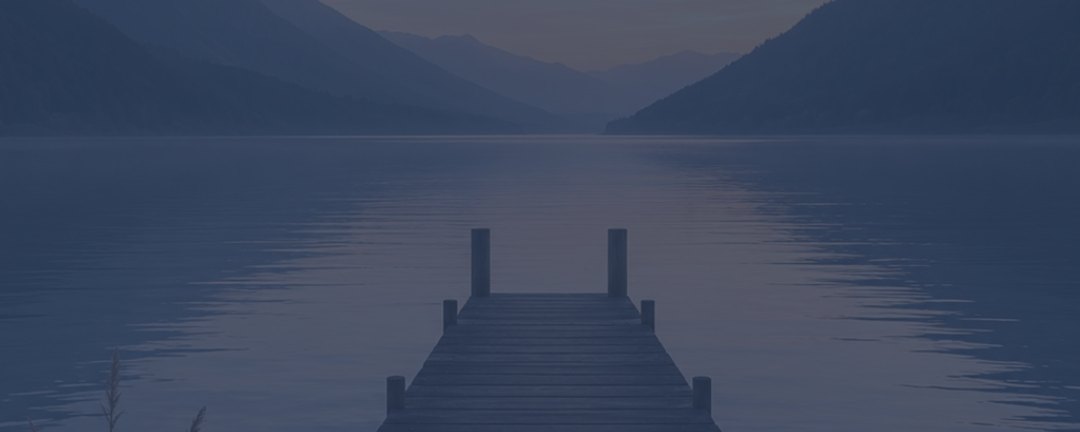 Achtsamkeits-Meditation – Videokurs mit geführten Übungen 2 Hintergrundgrafik: Steg am See bei Dämmerung mit Bergen im Hintergrund