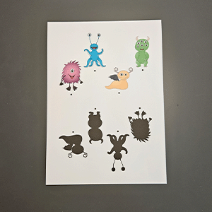 Ausdruckbare Monstersilhouetten in verschiedenen Farben und Formen auf weißem Papier