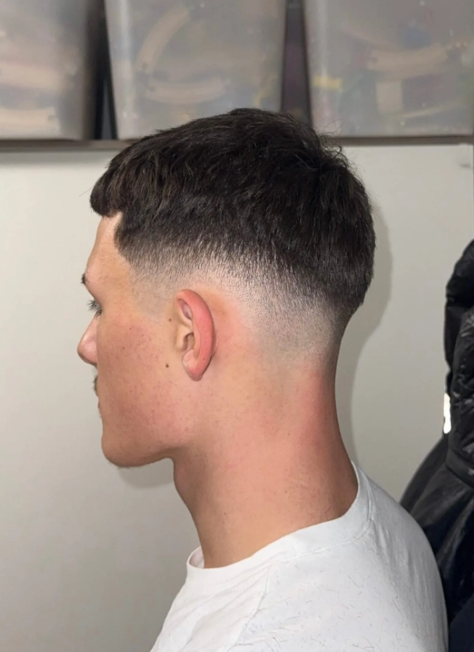 Seitenprofil eines Mannes mit modernem Haarschnitt, Fade-Technik Beispiel