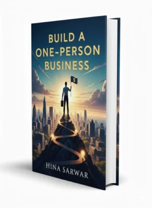 Build A One-Person Business eBook-Cover mit Silhouette einer Person auf Berggipfel vor Stadtkulisse und Sonnenaufgang