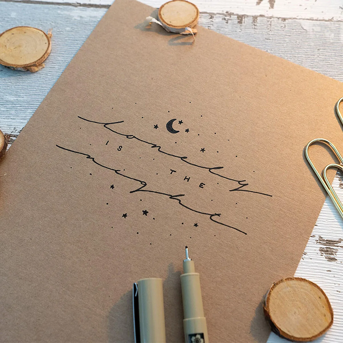 Extended Lettering Guide – E-Book zu breiten Schriftzügen 6 Handschriftliches Handlettering 'lonely is the night' auf braunem Papier mit Pinseln