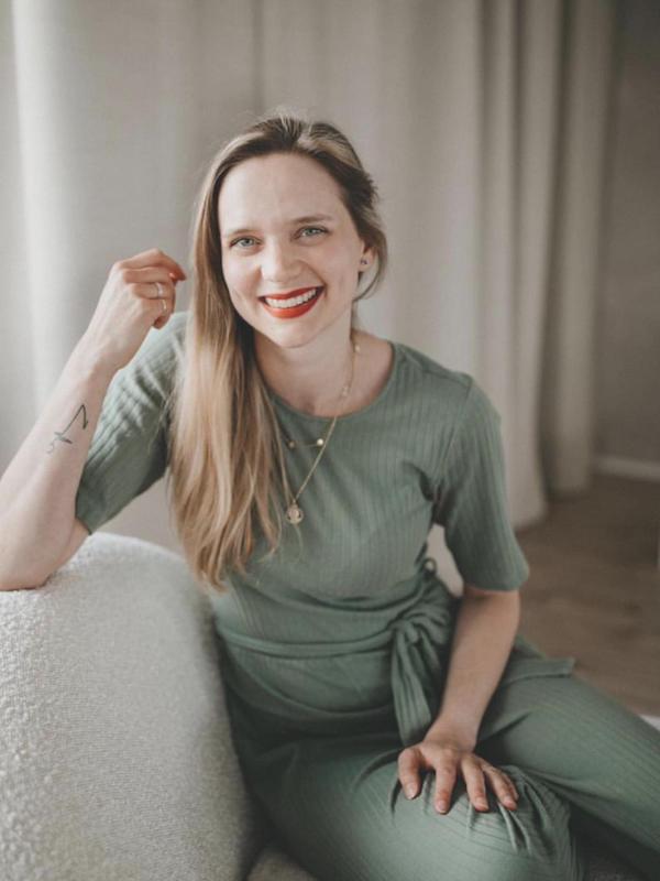 Farbe – Live-Workshop zur Farbberatung 10 Portrait einer lächelnden Frau im grünen Oberteil sitzend auf Couch
