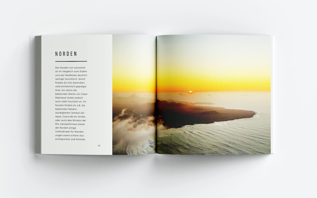 Aufgeschlagenes Buch zeigt Textseite Norden mit Vulkanlandschaft und Dünenlandschaft als Bildern über doppelte Buchseite