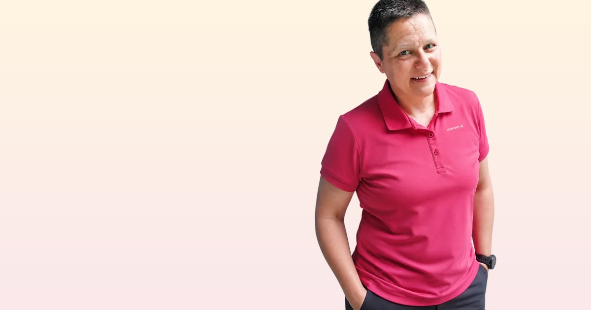 Karin Zeilinger in pink Poloshirt vor hellem Hintergrund, Porträtfoto für Business & Website mit KI