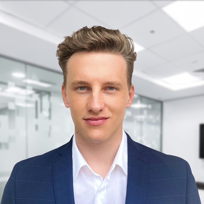 Professional headshot of Andreas Viertbauer in dark blazer and white shirt, modern office background