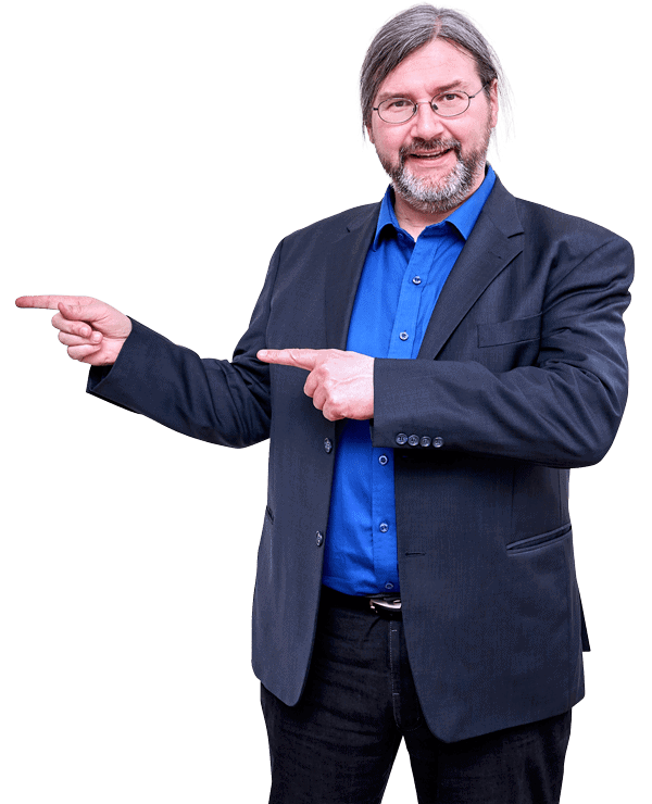 Mann mit Bart, Brille, blauem Hemd und Blazer deutet mit beiden Händen nach außen, Webinar