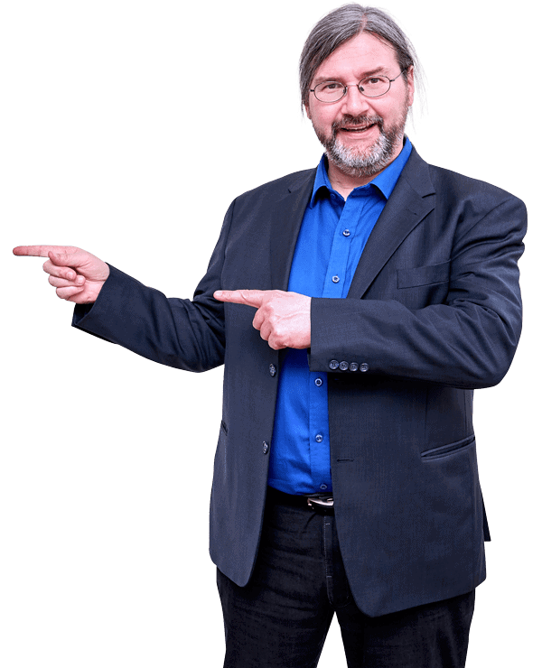 Mann mit Bart, Brille, blauem Hemd und Blazer deutet mit beiden Händen nach außen, Webinar