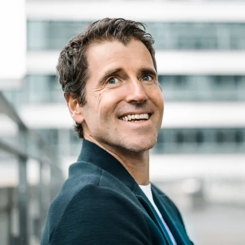 Claus-Stefan Duffner Portrait vor modernem Bürogebäude, lächelnd