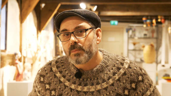 Christof N., Galerist, Portrait in Galerieraum mit Exponaten