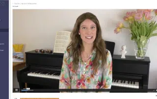 Videounterricht mit Susanna Proskura am Klavier in ihrem Studio mit Notenblättern