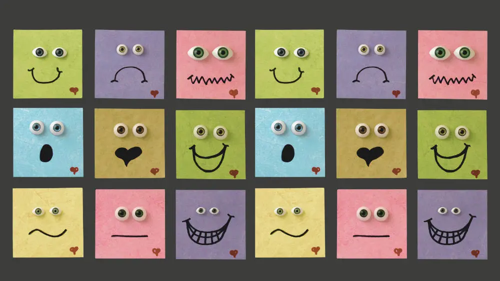 Grafik mit bunten Quadraten und gezeichneten Emotionen: Smiley, traurig, verärgert