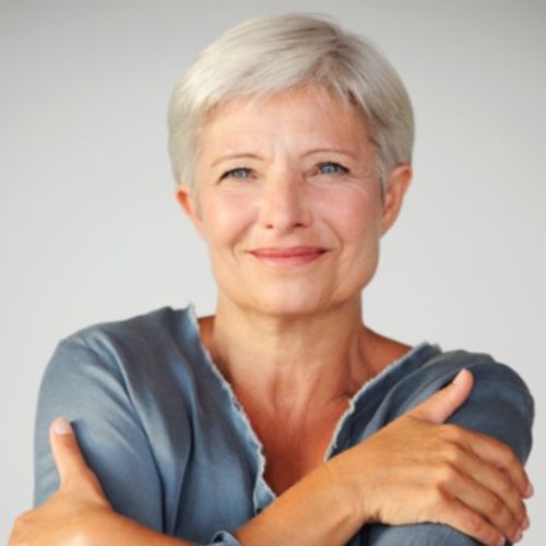 Porträt von Martina Haller, Frau mit kurzen weißen Haaren in blauem Shirt