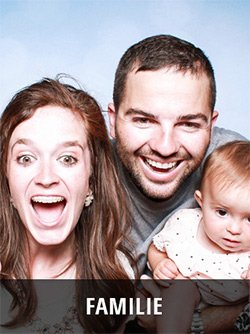 Familie mit Kleinkind, drei Personen lachen zusammen