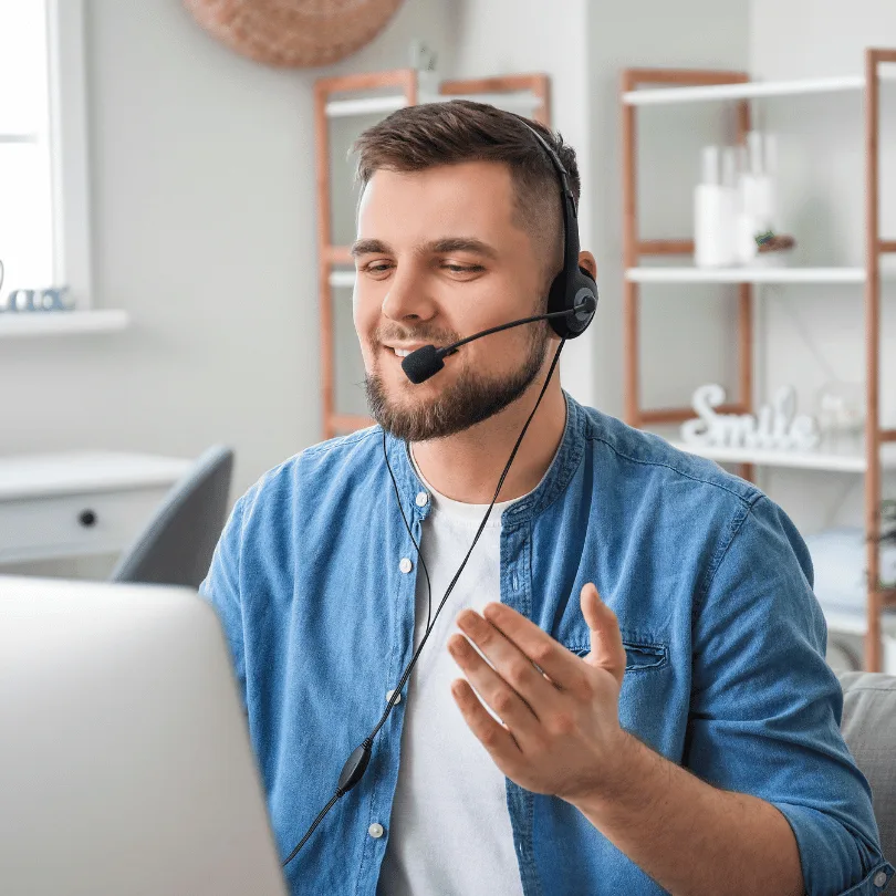 Telefonmarketing Agent mit Headset in Büroumgebung, sitzt am Schreibtisch und telefoniert