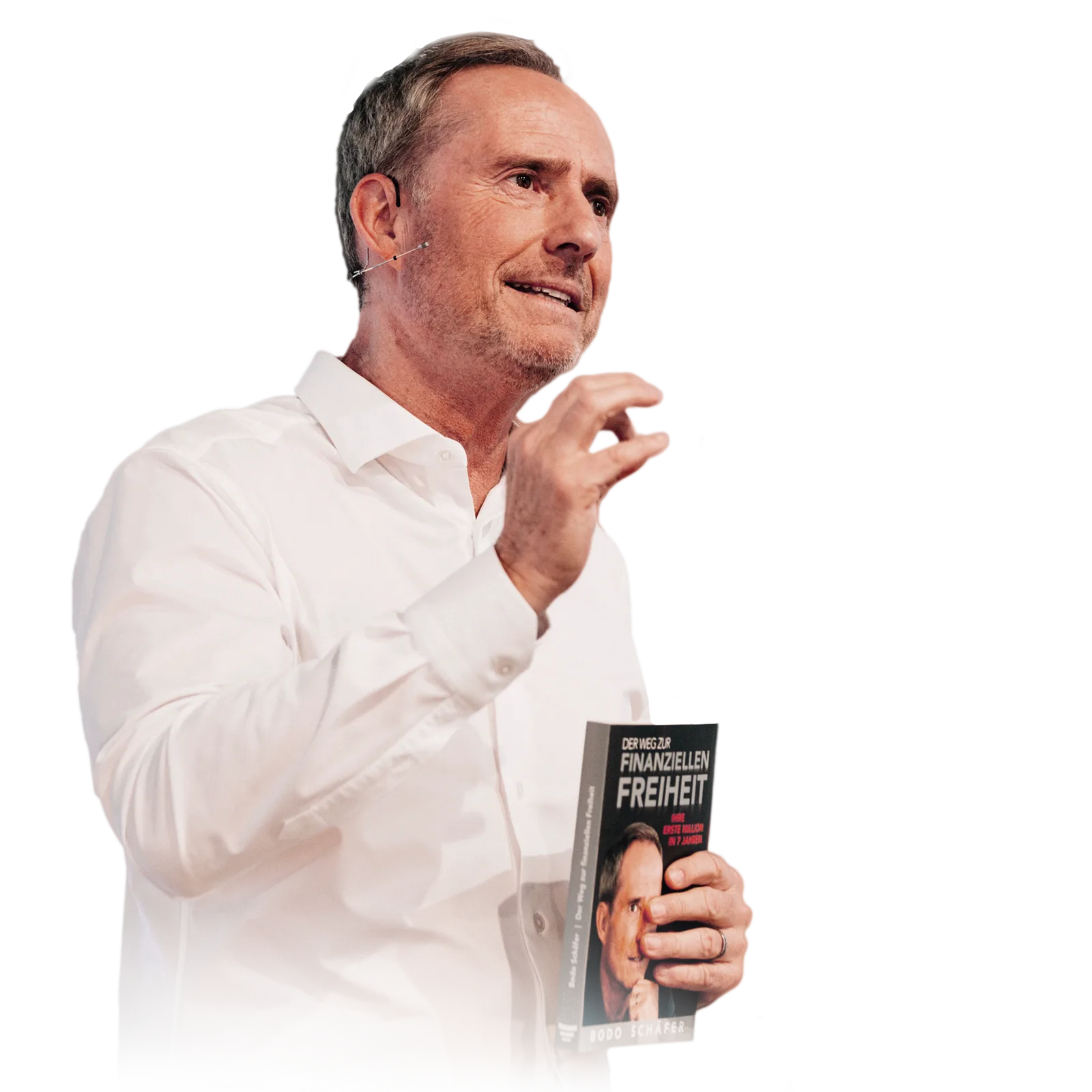 Bodo Schäfer mit Buch in der Hand: Der Weg zur finanziellen Freiheit