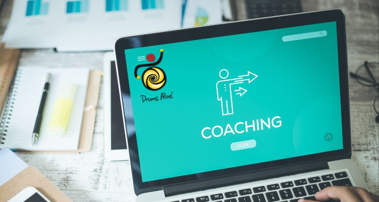 Laptop-Bildschirm zeigt Drums Alive Coaching-Webseite mit türkisem Design, Logo und Coaching-Icon