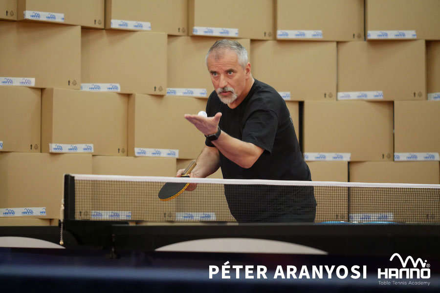 Pétér Aranyosi trainiert am Tischtennis-Tisch vor HANNO Branding im Hintergrund
