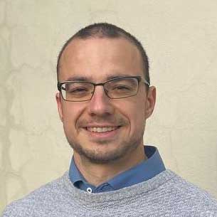 Porträtfoto von Dr.-Ing. Stefan Hügel, männlicher Speaker mit Brille in hellblauem Hemd