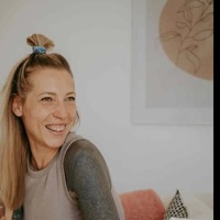 Profilportrait einer lächelnden Frau mit blondem Haar und Dutt