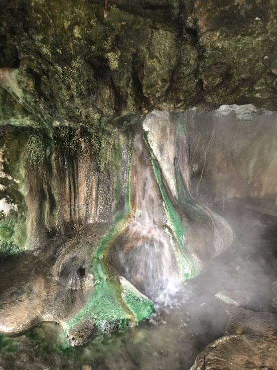 Wasserfall in Höhle mit grünem Moos und weißem Wasser
