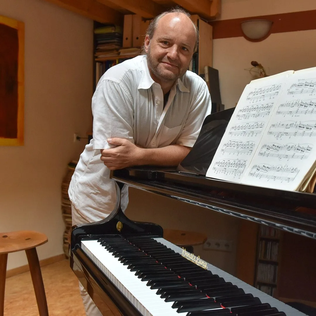 Jens Schlichting am Klavier mit Noten, Portrait in Studio