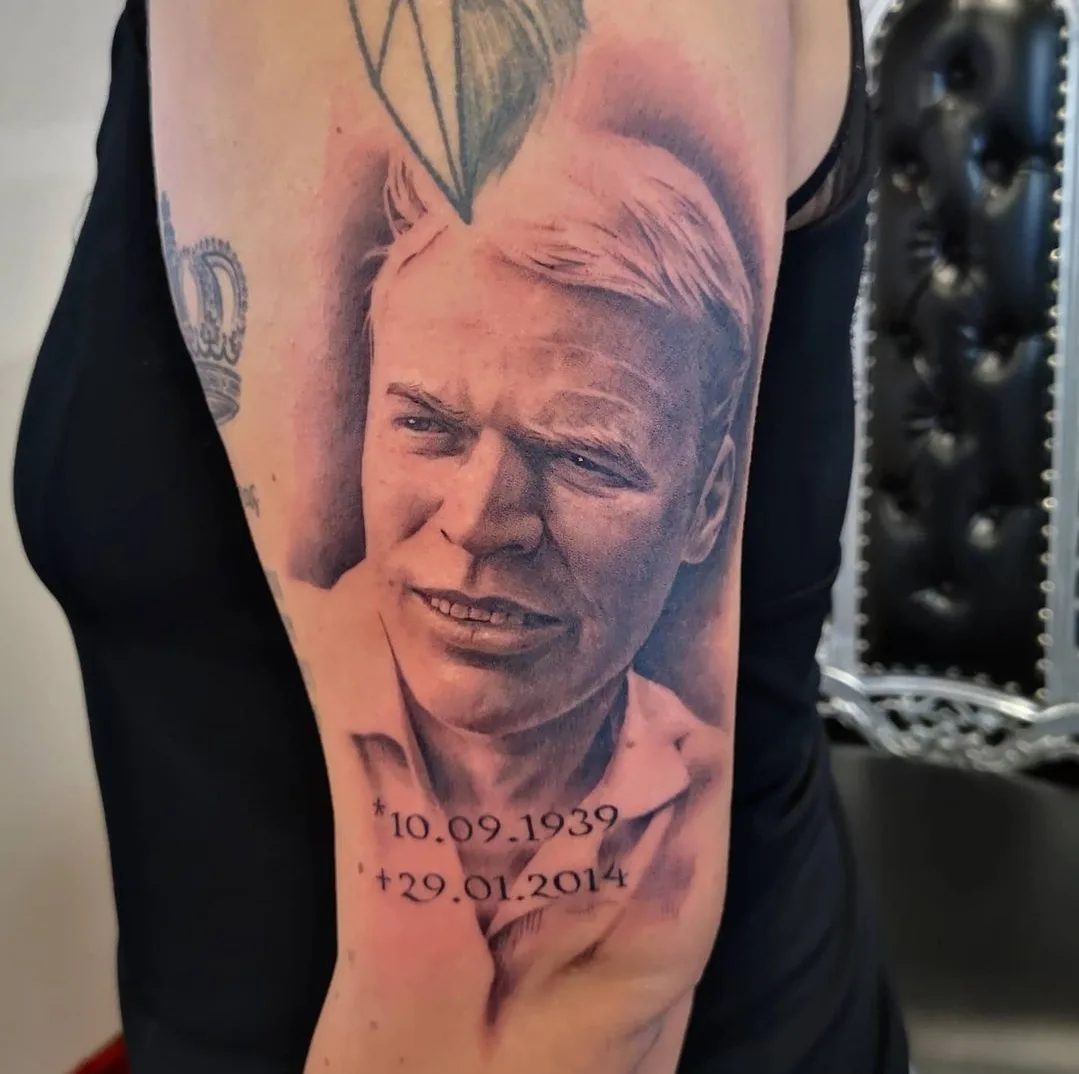 Portrait-Tattoo auf Arm: Männergesicht mit Daten 10.09.1939 + 29.01.2014 in Realismus-Stil