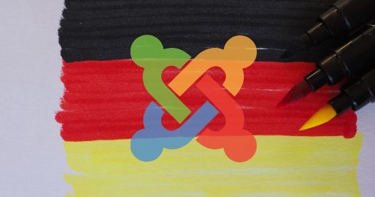 Joomla-Logo auf Deutschland-Flagge mit farbigen Stiften