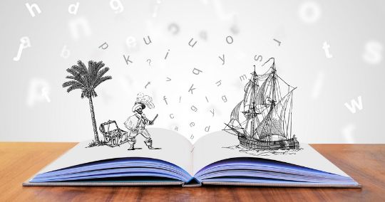 Aufgeschlagenes Buch mit illustrierten Palmen, Schiff und verteilten Buchstaben
