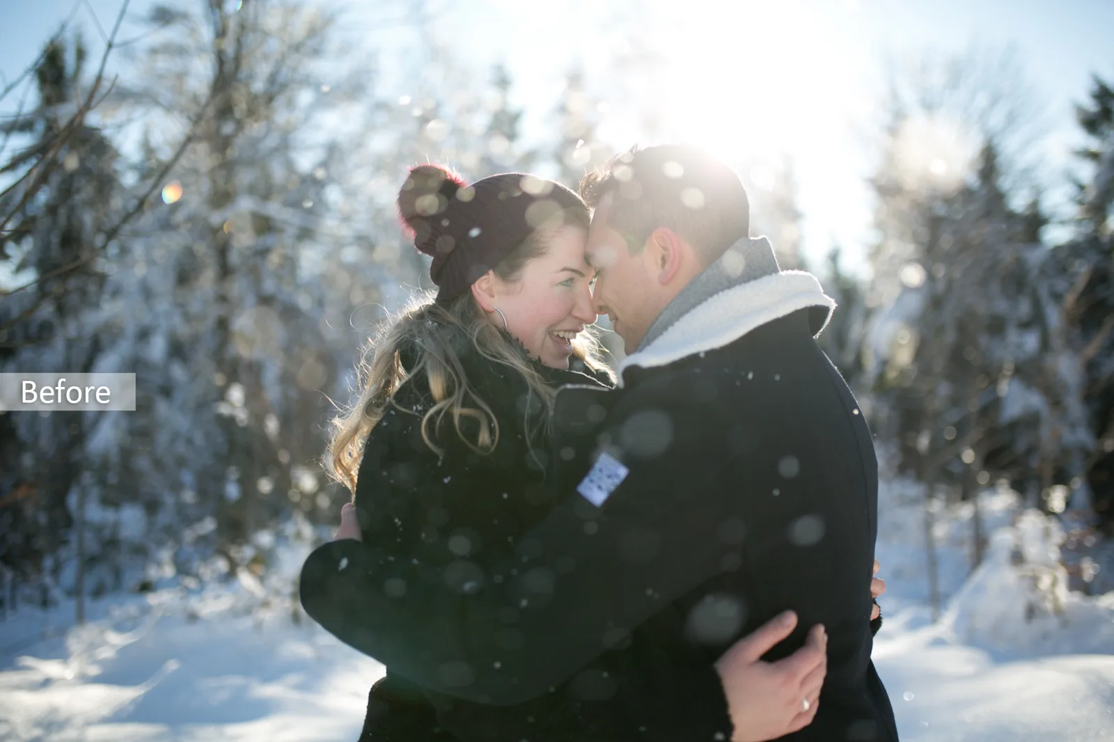 Before-Bild: Paar sich umarmend mit Gegenlicht in verschneiter Waldlandschaft mit Snowflakes